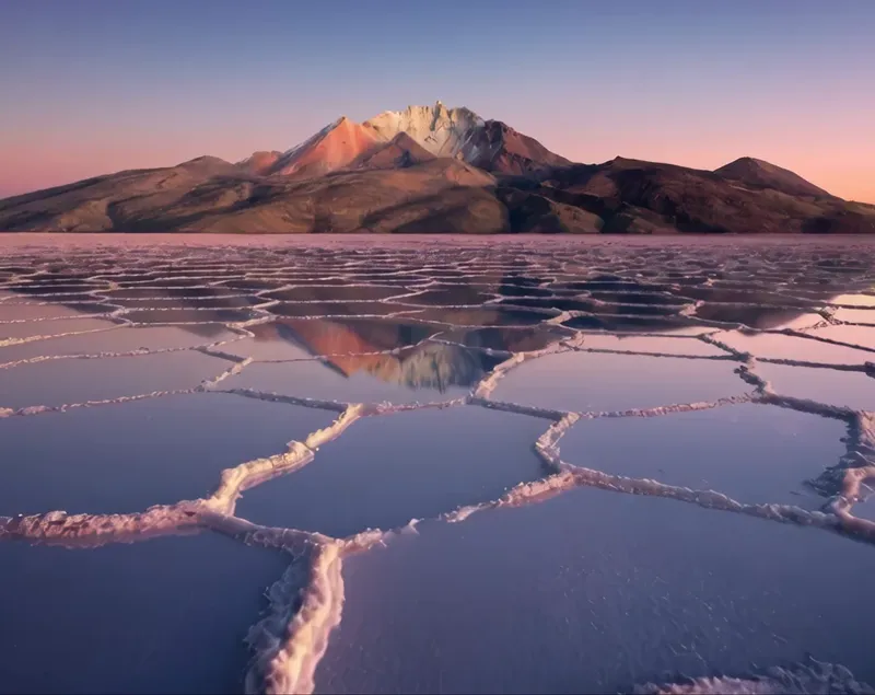 The salar at dusk under the volcano